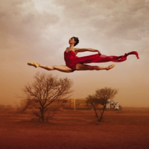 Leanne Benjamin leaps over the landscape near Alice Springs. Photo Jason Bell.