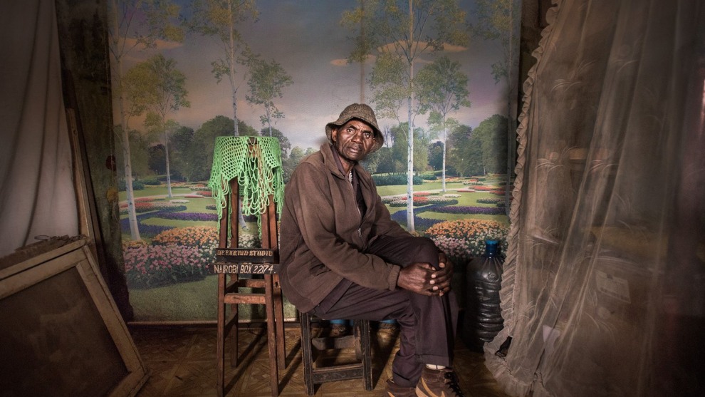 1st Place in People. Photograph and caption by Mia Collis / 2018 National Geographic Photo Contest. I was looking to do a series of portraits showing people wearing their Sunday best when I made this photo of David Muyochokera. It was taken on his last Sunday working as a photographer at Weekend Studio, in Kibera&mdash;a large shantytown in Nairobi, Kenya.

My friend Peter, a local resident, had pointed me to the photo studio just as I was about to leave the area. It was a stunning space, with whimsical backdrops and natural light coming through the doorway. David had worked there for 37 years, but Weekend Studio was about to close permanently. Phone cameras were so common now, he said, and fewer people wanted studio portraits. David planned to retire and return home to the countryside. I was troubled by the studio&rsquo;s imminent closure, so I eventually took over the rent. A portrait of David now hangs at Weekend Studio in his memory.