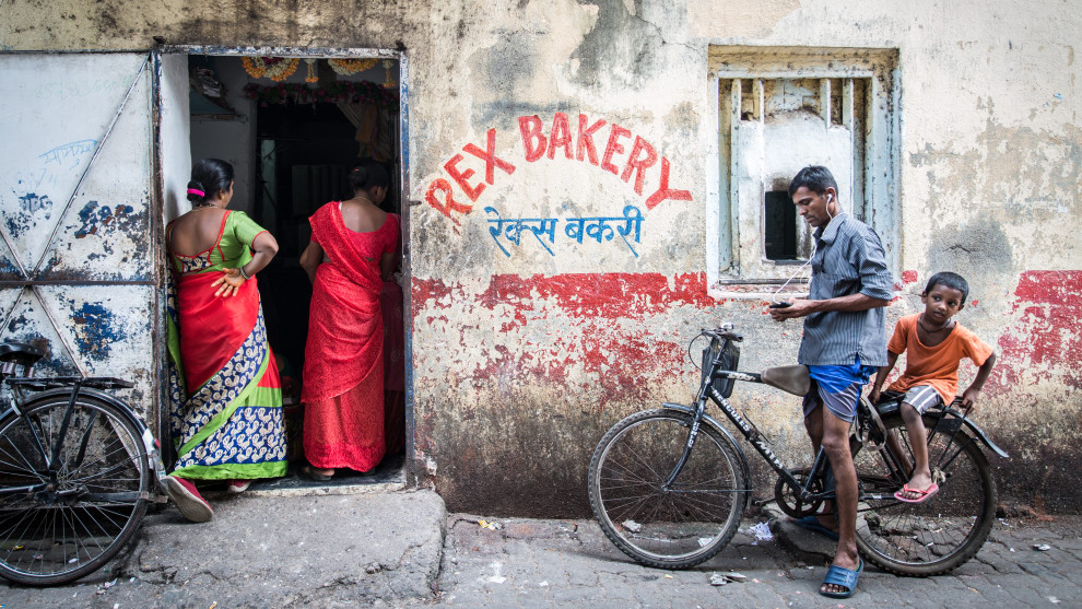 Food for Sale, Jade Nina Sarkhel, UK. Rex Bakery. Straddling a gutter, I captured the bullet-stricken walls of one of Mumbai&rsquo;s oldest bakeries. The bakery churns out 18,000 paos a day, operating 24/7 selling bread through the keyhole counter overnight. Bread is given for free to those who can&rsquo;t afford it. It&rsquo;s places like this that knit communities together in India.