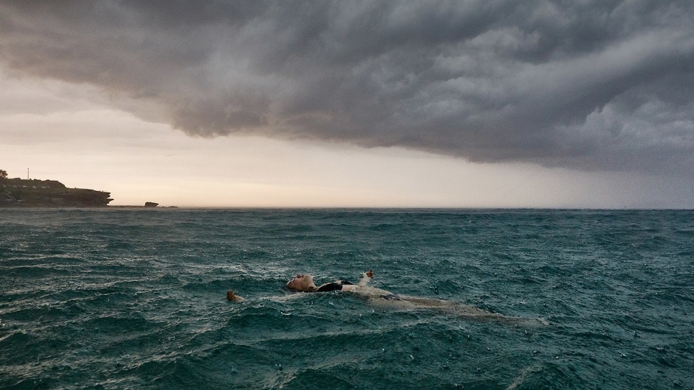 &copy; Paul Blackmore. Storm Swimmer. In the water off Bondi a swimmer embraces rainstorm.