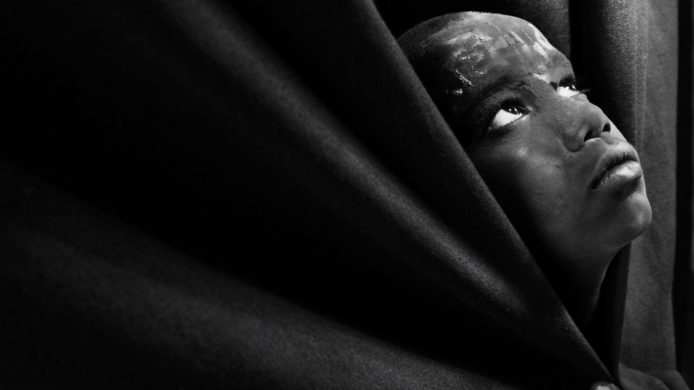 Photographer: Christopher Comeso, United Arab Emirates

"This was taken during my travel trip to India on their festival of Holi. saw this young Indian boy hiding on the Clothe and took a chance to take this awesome black and white."