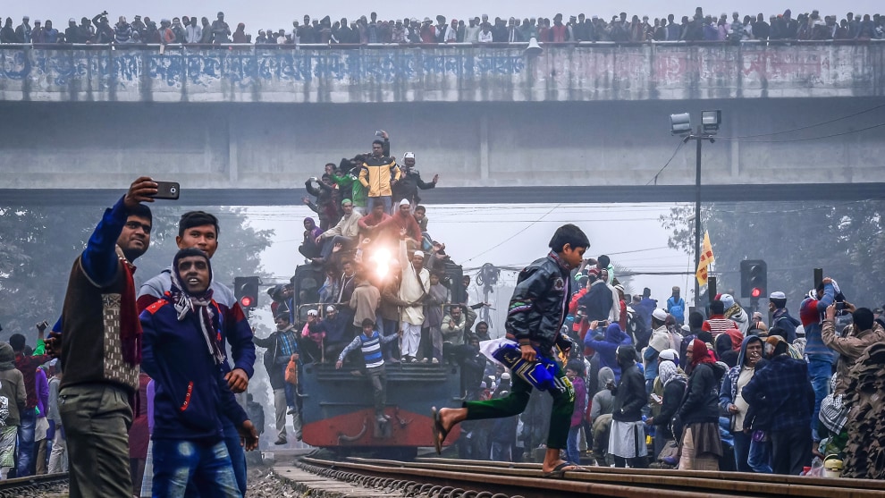 Copyright: &copy; Md. Akhlas Uddin, Bangladesh, Shortlist, Open, Street Photography (Open competition), 2019 Sony World Photography Awards. The overcrowded train and station at the early morning in Tongi railway station. Bangladeshi Muslim devotees attending the Akheri Munajat by train, On the third day of Biswa Ijtema, Bishwa ijtema is the second largest Muslim congregation after the Hajj, in Bangladesh, 14 January 2018, around one million Muslims from Bangladesh and abroad observed the three-day congregation with prayers on the banks of the Turag River, Tongi, Gazipur, Bangladesh.