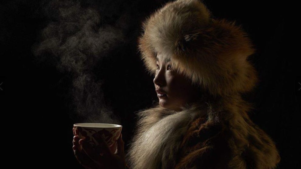 Tea Culture. For a long time, I have been fascinated by the ancient Mongolian method of hunting with Golden Eagles. In early 2018, I followed one family of eagle hunters during their migration from winter camp to spring camp.

Mongolia is sparsely populated, but the inhabitants have a very hospitable and welcoming culture. Tea for Kazakh culture is one of the attributes of hospitality. Tea isn't just a drink, but a mix of tradition, culture, relaxation, ceremony, and pleasure. Damel, seen here wrapped in heavy fur clothes, drinks a cup of tea to keep warm from the chilly temperatures in Western Mongolia. First place, People category. National Geographic Travel Photographer of the Year Contest. CREDIT: Photo and Caption by Alessandra Meniconzi / National Geographic Travel Photographer of the Year Contest