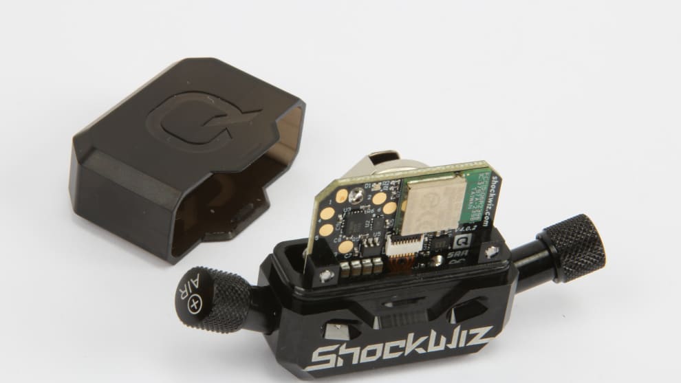 Taking a look inside; the small watch battery should power the Wiz through a few months of shock tinkering.