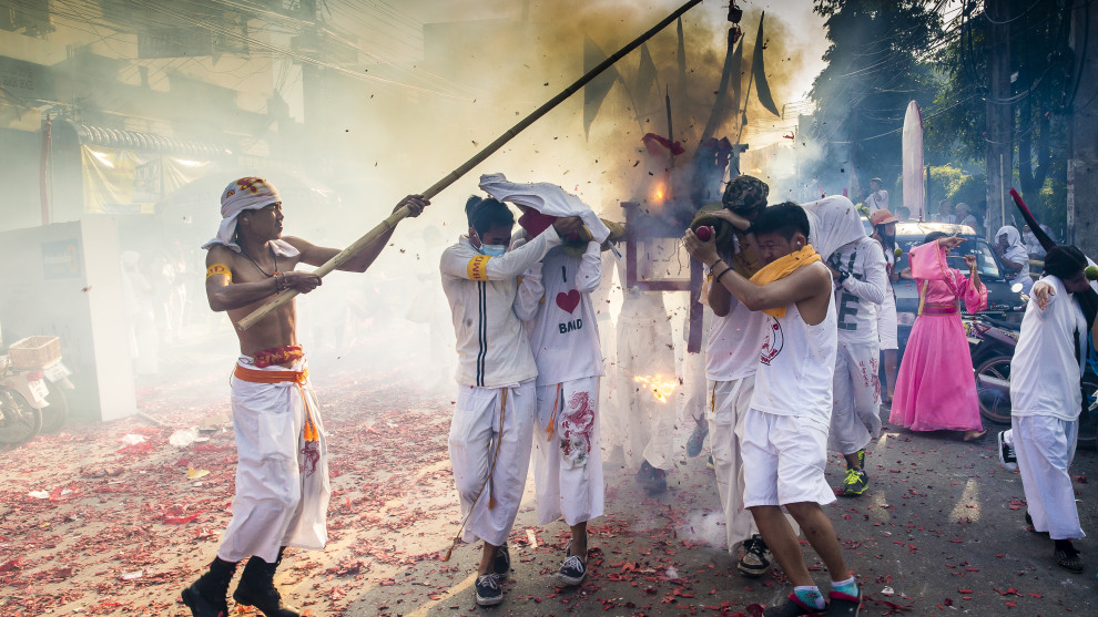 Procession at Vegetarian Festival, Phuket, Thailand. Loud, intense, scary, crazy! All of the above! The Vegetarian Festival is nothing like it sounds. Consequently, the images of devotees who have pierced their cheeks with all manner of objects including metal skewers, knives, chains, tree branches and even guns can be quite shocking. Canon 1D X, Canon 24-70mm lens @ 28mm, 1/250 @ f14, ISO 400.