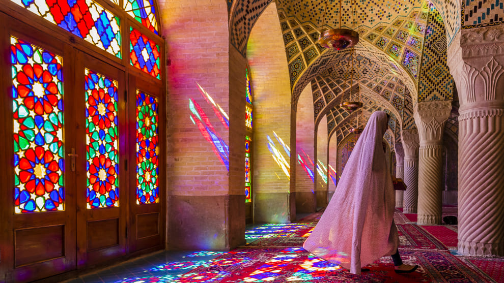 The beautiful Nasir-al-Molk Mosque, also known as the Pink Mosque, offers lots of interesting compositional possibilities as the sun streams through the stained glass windows, creating colourful patterns on the carpet and columns. Once the architecture was photographed, I turned my attention, as I always do, to looking for a more unique, less repeatable image. A challenge I set myself at every location. This woman was sitting on the carpet posing for her friend&rsquo;s camera, not to mention other tourists who were crowding around trying to grab a shot of their own, something that I don&rsquo;t like to see as it happens to me a bit. So, I waited until they had finished and were moving away, which they did as soon as the woman started to stand up, leaving me as the only one to see and capture this fleeting moment, as opposed to the posed shots they set up. I&rsquo;ve learnt never to put my camera down or turn my back on an opportunity until I am absolutely sure there is nothing more to see.