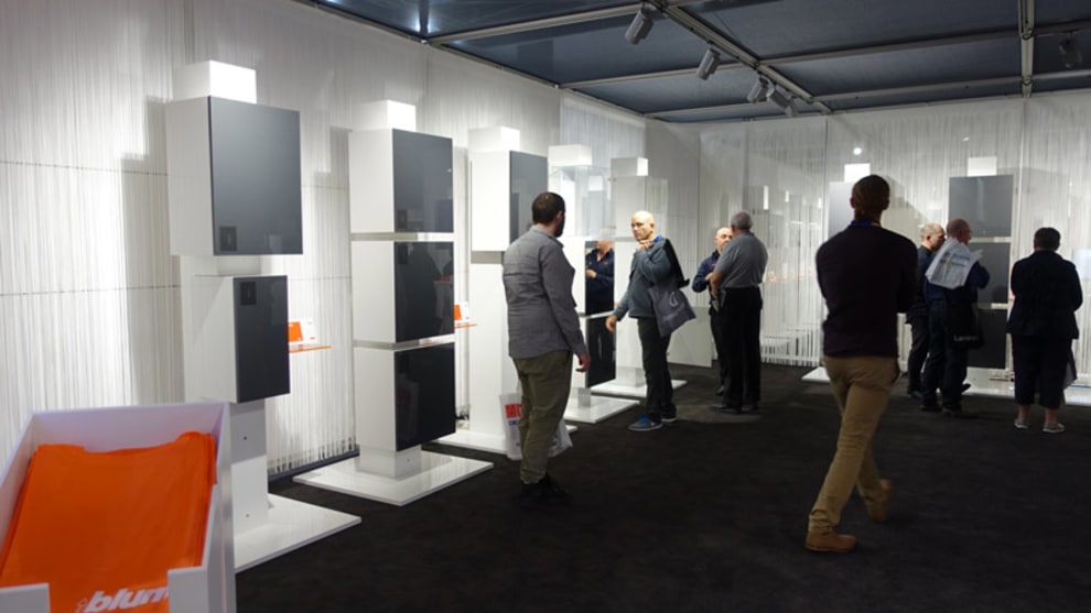 Blum display of furniture fittings including hinges that work for thin panels and utilise 'Blumotion' soft close technology.
