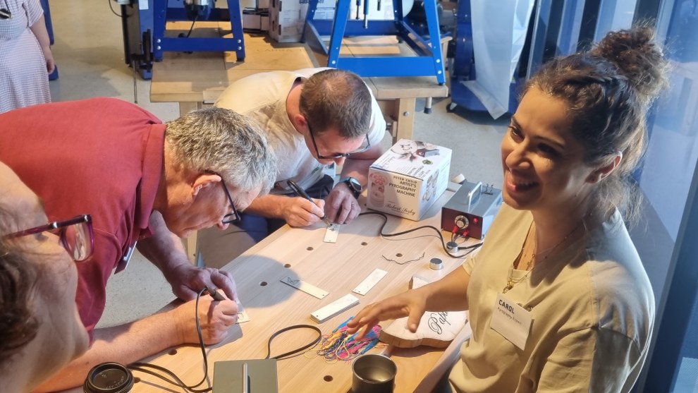 A place to try tools out: Carol Black from Burning Bird Pyrography gives visitors an opportunity to experiment.