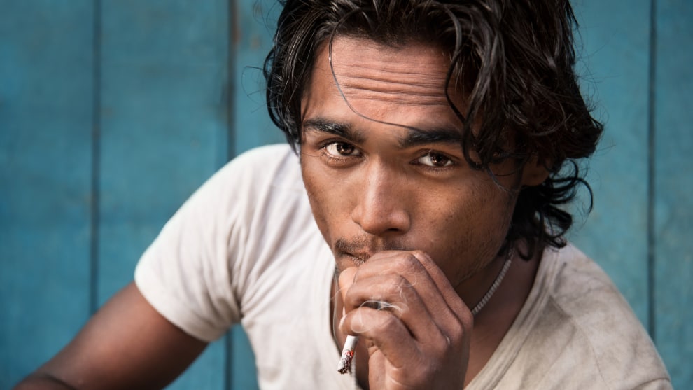 The background here is even and blue which compliments the young Bengali man and adds a sense of calmness with a focus on the man. The photo was actually taken in a market place, with very cluttered and busy scenes all around. I had him squat down to provide a natural and relaxed body posture, instead of simple standing up for a less intimate feeling portrait. Nikon D800, 24-85mm f2.8-4 lens @ 70mm, 1/125s @ f5.6, ISO 500.