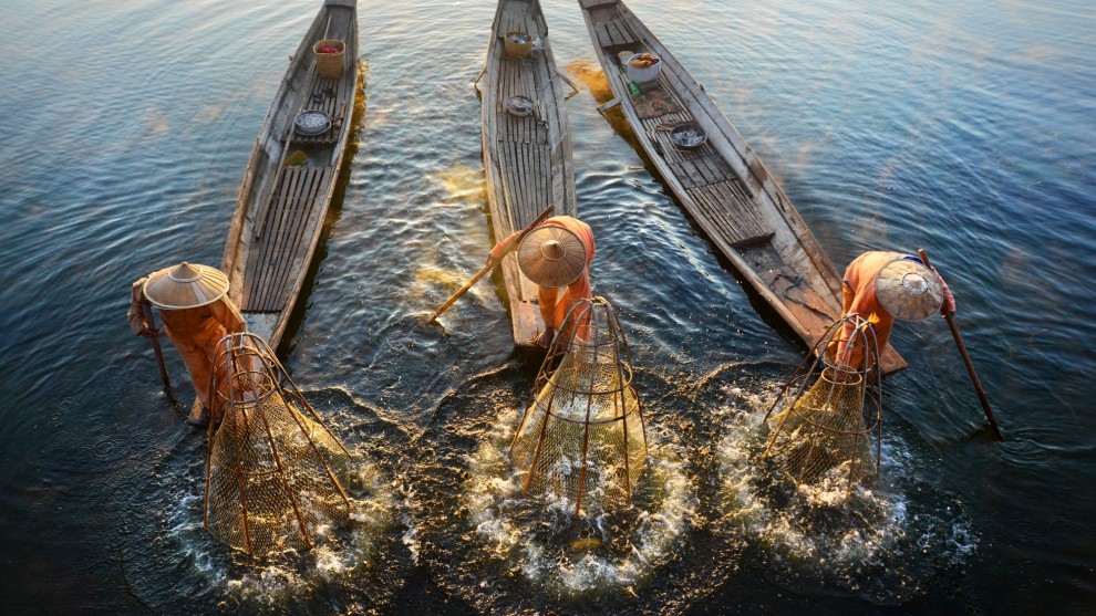 Fishermen on Inle Lake, Myanmar, shot from a bridge &copy; David Lazar