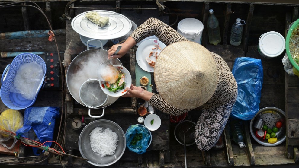 Mekong Delta breakfast, Vietnam, shot from a wooden balcony. I ordered some food at an early morning floating market in order to capture the circular shapes, especially from the lady&rsquo;s hat which is so iconic to Vietnam.&nbsp;Nikon D800, 24-85mm f/2.8-4 lens. 1/160s @ f10, ISO 400.&nbsp;