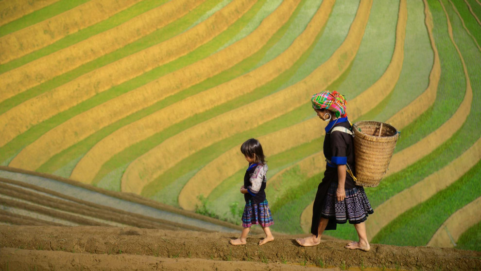 Taken in northern Vietnam, I composed this photo of the Black H&rsquo;mong tribespeople against a background consisting only of repeated, curved lines. A subject photographed in front of a repeatious, patterned background will help draw attention to the subject and create an aesthetically powerful image.&nbsp;
Nikon D800, 24-85mm f/2.8-4 lens. 1/2000s @ f4, ISO 400.