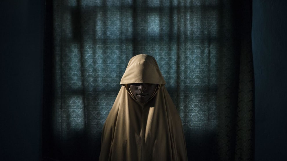 Boko Haram Strapped Suicide Bombs to Them. Somehow These Teenage Girls Survived. World Press Photo of the Year Nominee. &copy; Adam Ferguson. Aisha (14) stands for a portrait in Maiduguri, Borno State, Nigeria. After being kidnapped by Boko Haram, Aisha was assigned a suicide bombing mission, but managed to escape and find help instead of detonating the bombs. Commissioned by The New York Times.