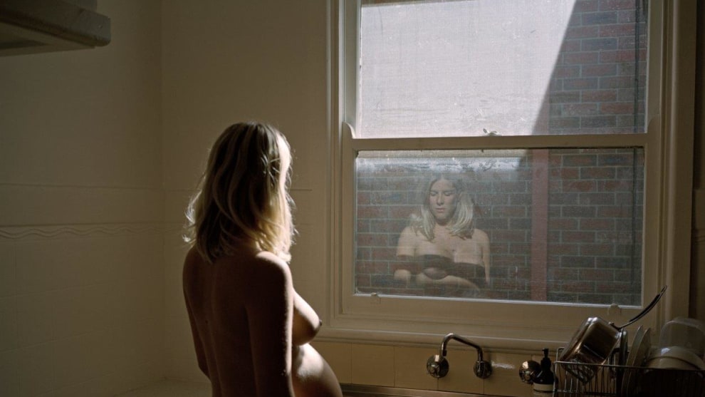 Greta in her kitchen, 36 weeks, 2018. &copy; Alana Holmberg. Pregnancy carried my sister into a new chapter of her life and she welcomed it warmly. Effortlessly. Ready for things to change. We&rsquo;d spent much of our late twenties debating the &lsquo;right time&rsquo;, if there was even such a thing, but she&rsquo;d found it. This portrait is an attempt to depict the tranquility in Greta&rsquo;s transition into motherhood, and her trust in the future.