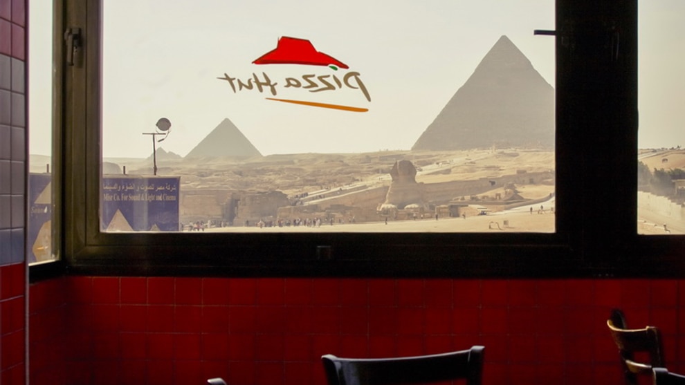 FIRST PLACE &ndash; Roger Grasas - Giza Pyramids
&ldquo;View of the pyramids and the Sphinx of Giza (Egypt) from the dining room of a well-known American restaurant of pizzas and fast food.&rdquo;