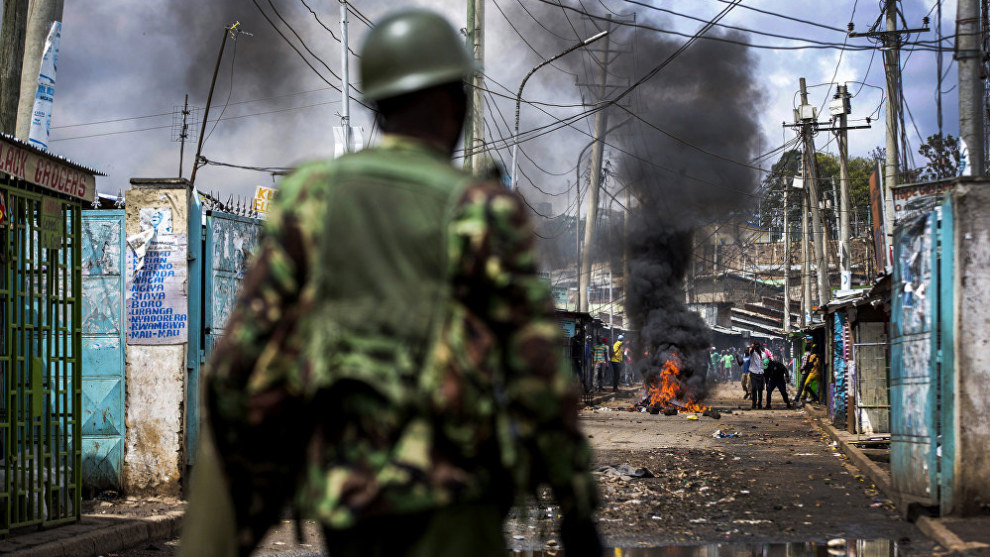 Photo: Luis Tato, Spain. First place, News, Series, 2018 Andrei Sennin International Press Photo Contest. 
A Kenyan policeman looks on as as a barricade burns in Mathare, Nairobi. Barricades were set up by protesters attempting to prevent voters from accessing a polling station in presidential elections.