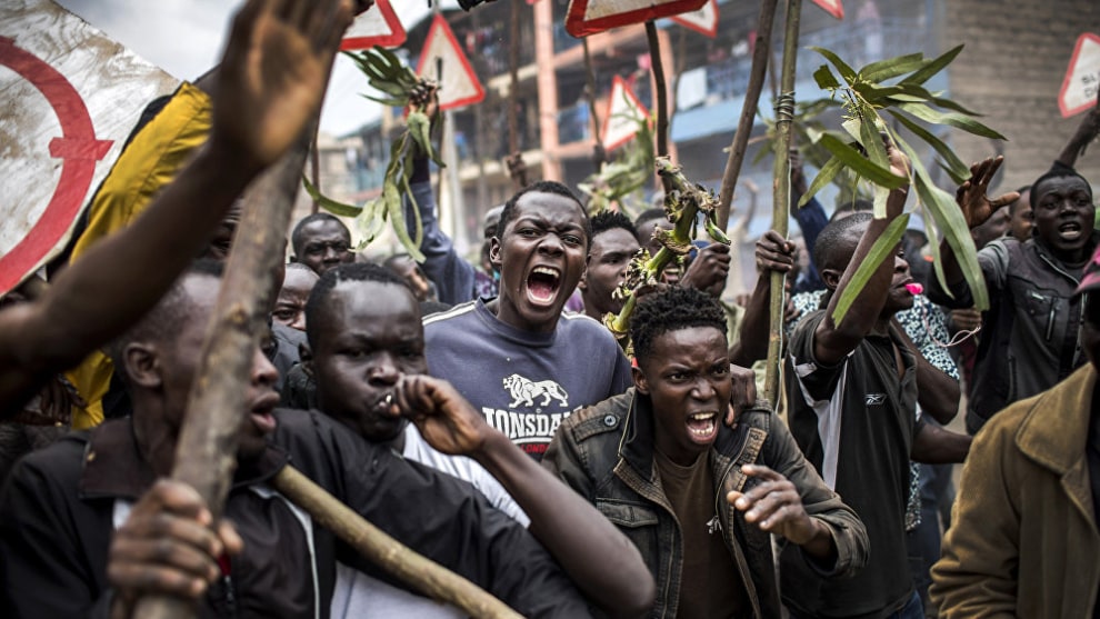 Photo: Luis Tato, Spain. First place, News, Series, 2018 Andrei Stennin International Press Photo Contest. 
Supporters of the Kenyan opposition presidential candidate shout and hold sticks during a protest in the Mathare slums of Nairobi on August 9, 2017, a day after the presidential election.