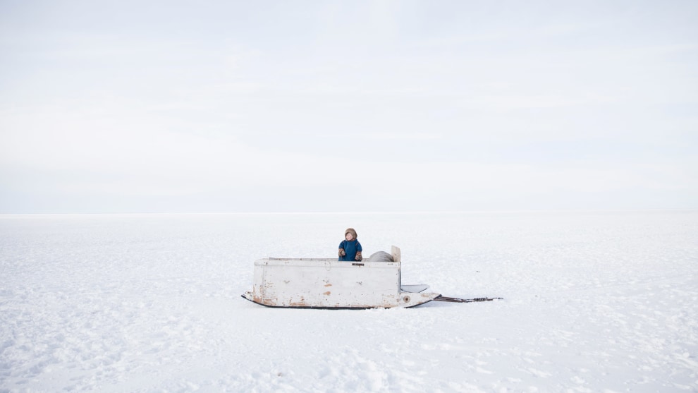 Photo: Oded Wagenstein, Israel. First Place, Portrait, Single, 2018 Andrei Sennin International Press Photo Contest. 
A child from the nomadic Nenets tribe stands on the family's wooden sleigh, during their migration over the river of Ob. Yamal Peninsula, Siberia, Russia. March 2017.