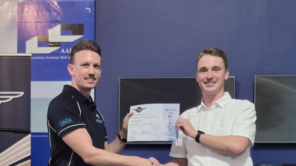 Young Achiever of the Year receives his award from Shaun Holmes