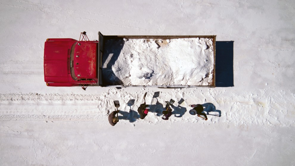 &copy; Josh Haner/The New York Times. Red truck in salt flat. Members of the Uru indigenous group who have migrated to work in the salt flats of Salar de Uyuni, Bolivia, instead of being fishermen, because the lake they based their livelihood on has dried up and they&rsquo;ve been forced to look for other sources of income.