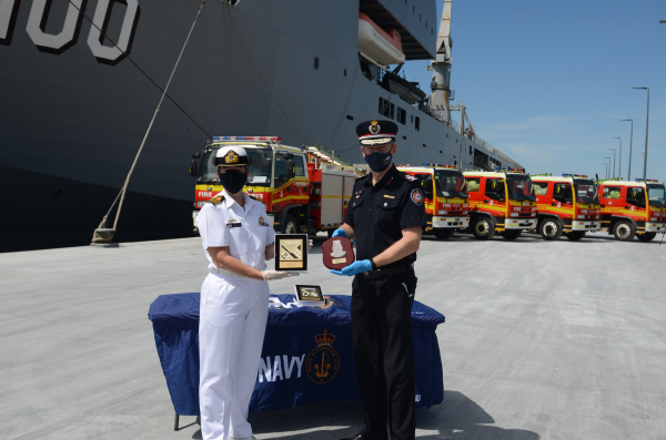 Commanding Officer HMAS Moreton, Commander Phillipa Hay, and Queensland Fire and Emergency Services Commissioner Greg Leach at the loading of five fire trucks onto HMAS Choules at Pinkenba, Brisbane. (Credit: Defence)