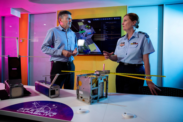 Head of Air Force Capability Air Vice-Marshal Cath Roberts AM, CSC (right) speaks with Professor Russell Boyce about the M2 CubeSat at the UNSW Canberra. (Supplied: Defence)