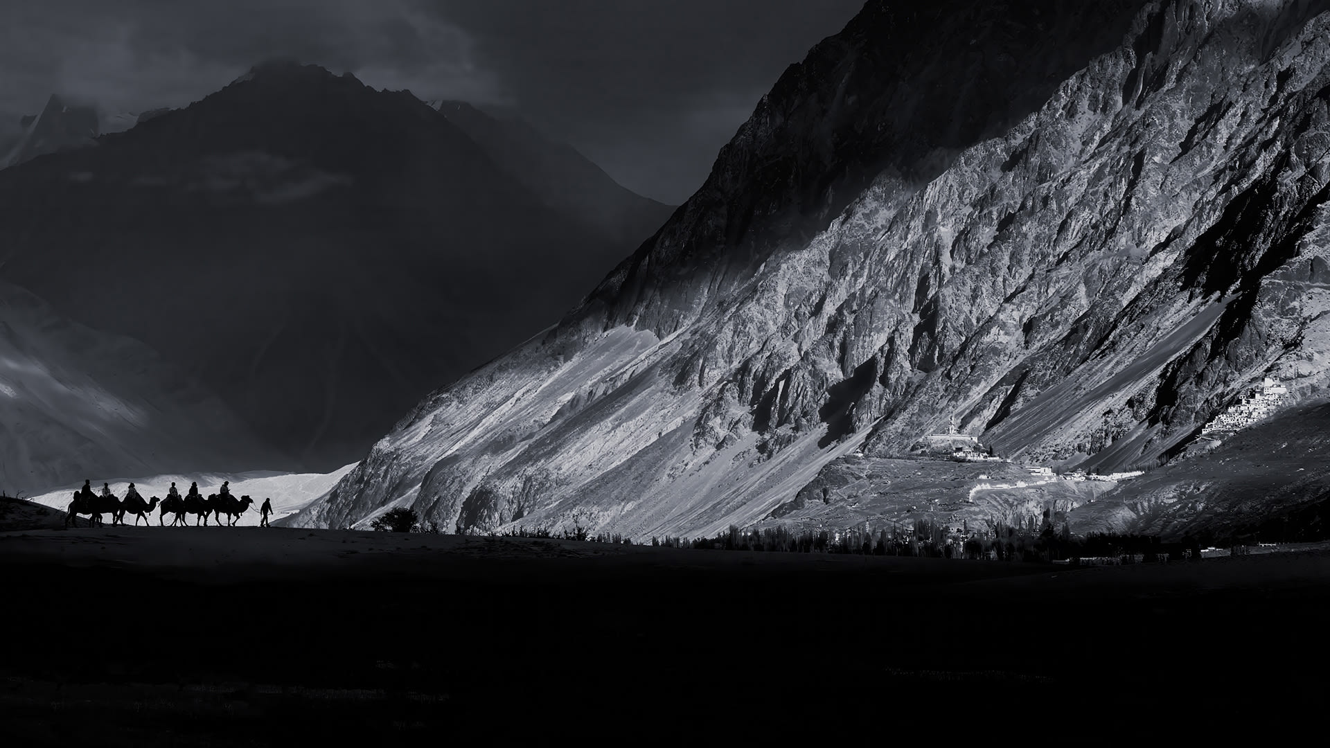 3rd place, Bruce Westerman, Echoes of the silk road.As the sun slips behind the rugged peaks of the Himalayas, its final rays sweep across the barren slopes of the Nubra Velley, illuminating the ancient Diskit Monastery perched above the valley floor. Below a caravan Bactrian camels, silhouettes etched against the fading light. the scene captures the timeless spirit of this remote corner of Ladakh.
