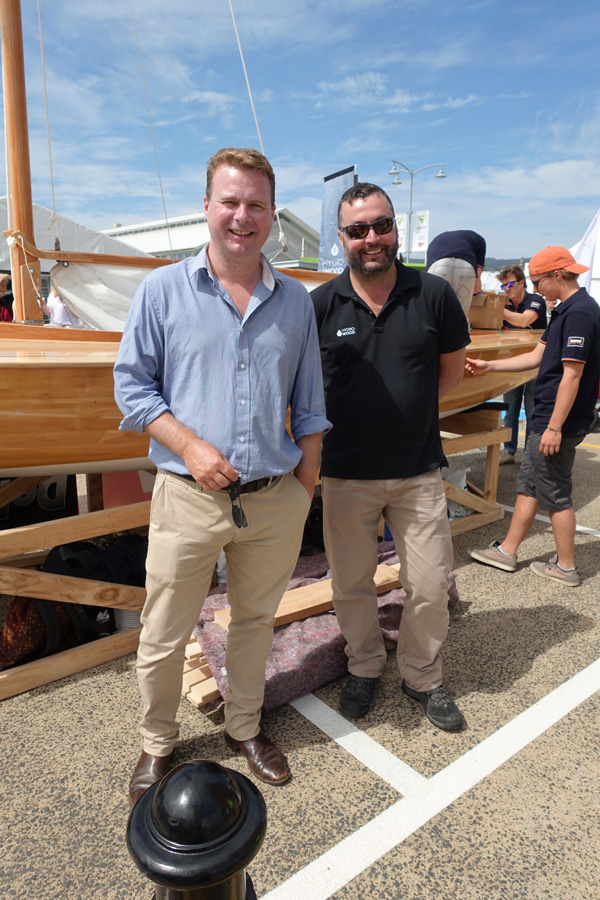 Andrew Morgan and David Wise, directors of Hydrowood stand before the Dutch boat built from Hydrowood celery top pine especially for the festival.