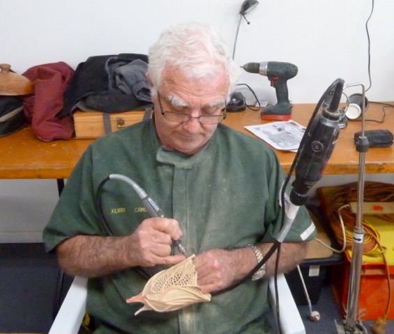 Kerry Cameron embellishing and turned and carved piece with the use of a Dremel tool.