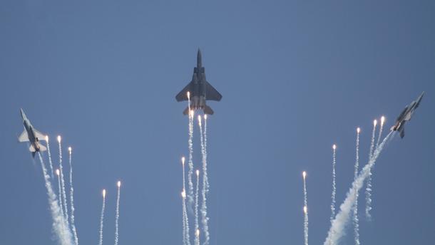 Republic of Singapore  Air Force F-15SG and two RSAF F-16s drop flares during an aerobatic display on the opening day at Changi Airport, Singapore. Credit: Nigel Pittaway
