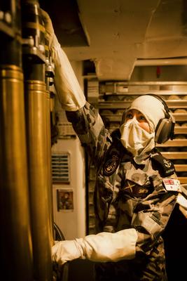 RAN sailor LSET Ci-Anna Smith checks the ammunition for the 76mm Naval Gun while deployed aboard HMAS Melbourne. Credit: Defence