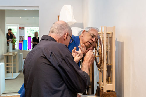 David Boucher takes a closer look at Will Matthysen&rsquo;s clock with the maker on hand to answer questions. Photo: Julijana Griffiths