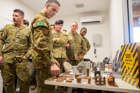 Australian Army soldiers check out the parts created using 3D printing technology. (CDU)