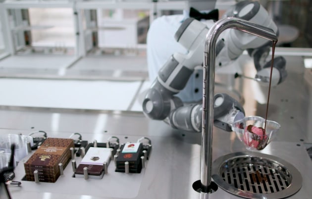 ABB's Yumi robot, named Tony in the Niska store, adds toppings to the ice cream bowls.