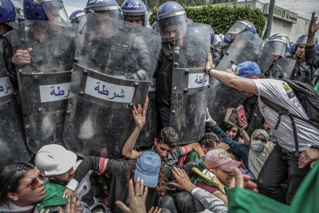 World Press Photo of the Year Nominee. &copy; Farouk Batiche, Algeria, Deutsche Presse-Agentur. Students scuffle with riot police during an anti-government demonstration in Algiers, Algeria, on 21 May.