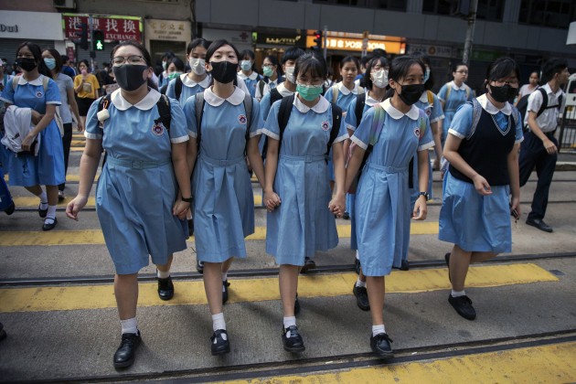 Nominee for the World Press Photo Story of the Year. &copy; Nicolas Asfouri, Denmark, Agence France-Presse. Hong Kong Unrest. Students cross a road to school after participating in a human-chain rally, in Hong Kong, on 12 September 2019.