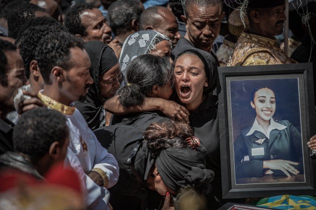 Nominee for the World Press Photo Story of the Year. &copy; Mulugeta Ayene, Ethiopia, Associated Press. Ethiopian Airlines Flight 302 Crash Site. Relatives hold a photograph of a victim of the crash of Ethiopian Airlines Flight ET302 at a mass funeral at the Holy Trinity Cathedral in Addis Ababa, Ethiopia, on 17 March 2019.