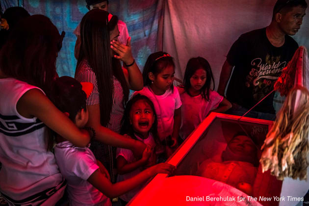 General News - First Prize, Stories. They Are Slaughtering Us Like Animals. Six-year-old Jimji cries in anguish as she screams "papa" before funeral parlor workers move the body of her father, Jimboy Bolasa, from the wake at the start of the funeral to Navotas Cemetery in Manila, Philippines. Unidentified men abducted Mr. Bolasa and a neighborhood friend one night. Less than an hour later, their beaten bodies, with signs of torture and gunshot wounds, were dumped under a nearby bridge. The police claim the men were alleged drug dealers while their family members say they had only surrendered themselves. &copy; Daniel Berehulak, for The New York Times.