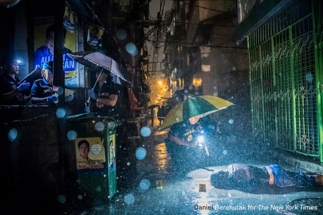 General News - First Prize, Stories. They Are Slaughtering Us Like Animals. Heavy rain pours as police operatives investigate inside an alley where a victim, Romeo Joel Torres Fontanilla (37) was killed by two unidentified gunmen riding motorcycles in the early morning in Manila, Philippines. &copy; Daniel Berehulak, for The New York Times.