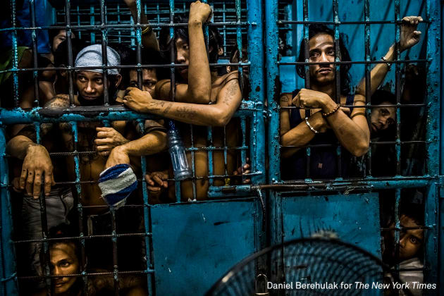 General News - First Prize, Stories. They Are Slaughtering Us Like Animals. Inmates watch as drug suspects are processed inside a police station in Manila, Philippines. &copy; Daniel Berehulak, for The New York Times.