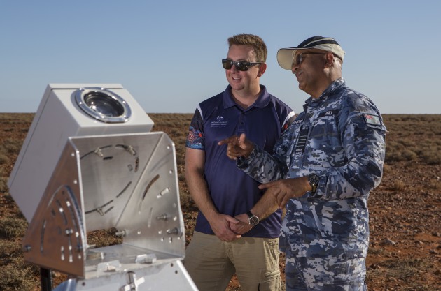 DST and RAAF personnel in front of a FireOPAL sensor developed in collaboration between Curtin University and Lockheed Martin Australia during SpaceFest 2019 at the Woomera Test Range in SA. (Defence)