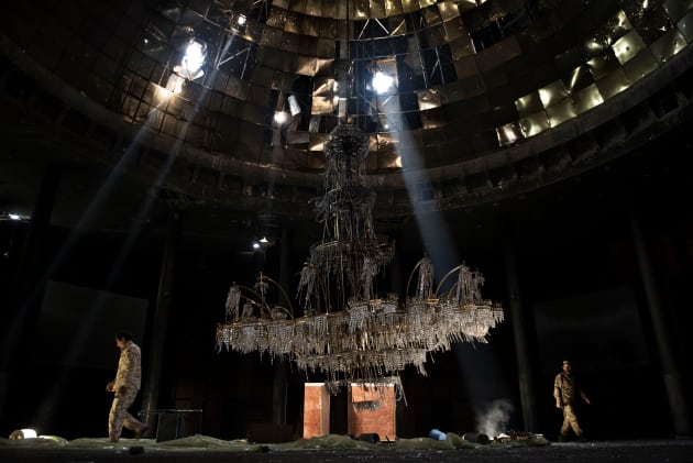 "We are taking no prisoners". Sirte, Libya, July 14, 2016: Fighters of the Libyan forces affiliated with the Tripoli government walk around the gigantic chandelier of the conference room in the Ouagadougou conference centre. &copy; Alessio Romenzi, Italy, 1st Place, Professional, Current Affairs & News, 2017 Sony World Photography Awards.