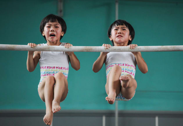 The twins' gymnastics dream. This series was taken in a sports school in Jining, in Shandong province, China. Liu Bingqing and Liu Yujie are twin sisters, who have liked gymnastics since their childhood. They have studied, trained and grown up here. &copy; Yuan Peng, China, 1st Place, Professional, Sport, 2017 Sony World Photography Awards.