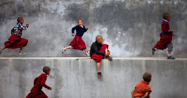 &copy; Aruna Bhat
1st Prize &ndash; Life in Colour category. &ldquo;This photograph was taken in Ki Gompa, a monastery of Tibetan Buddhists in the Indian Himalayas. Every evening, the young monks of the temple are given time off to play in an open area nearby. These young monks, in their richly coloured robes, manifest the true meaning of enthusiasm and cheerfulness, unlike the greyness of the walls behind them.&rdquo;