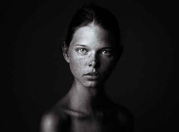 &copy; Rudoi Vladimirovich
1st Prize &ndash; Faces (Black and White) category. This photograph was taken inside a photography studio and is of a young girl named Stella-Maria. With her deep stare, Stella-Maria is able to captivate the viewer through her innocence and youth, whilst being presented in classic black and white. The shadow covering part of her face also adds to the intrigue in this young lady.