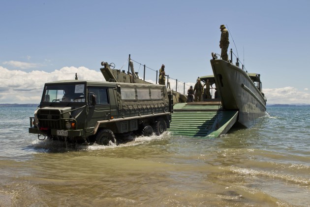 A Pinzgauer truck from 1 RNZIR drives off an Australian Army Landing Craft for amphibious operations on the Whangaparaoa Peninsula, New Zealand, in 2012. (Defence)