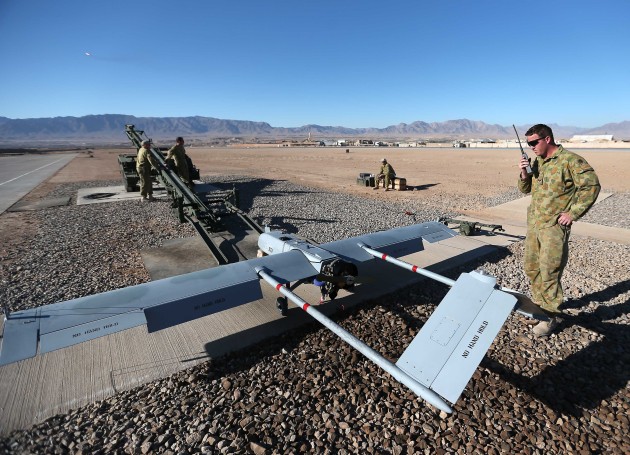 Corporal Scott McMahon, a Shadow Unmanned Aerial Vehicle maintainer and ground crew chief, communicates via radio with a Shadow launch commander during the pre-flight phase of a mission. Defence