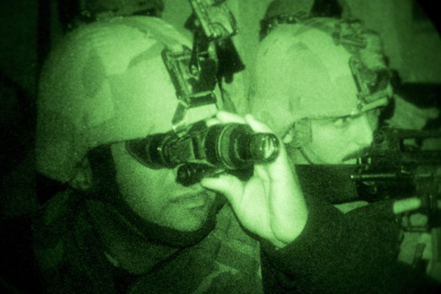 An Iraqi Army soldier (left) scans the area with night vision equipment during a night exercise at the Taji Military Complex, Iraq. Defence