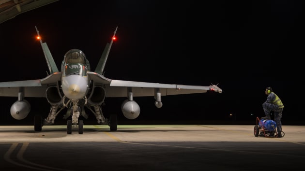 A 77SQN ground crew member assists a 77SQN pilot with his pre-flight checks during Ex Pitch Black 2016. Defence