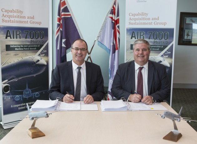 Tony Fraser, left, pictured in 2016 signing the P-8A contract. Defence